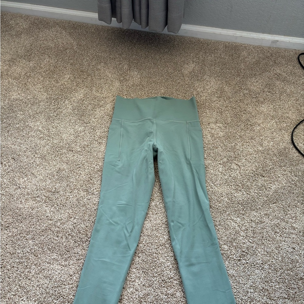 Athleta Salutation Stash Tight in Soft Green